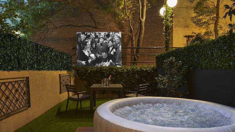 Outdoor hot tub with movie night in the garden