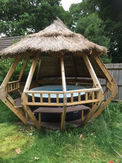 Inflatable hot tub in a unique thatched structure