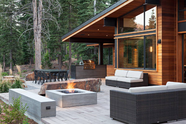 Modern patio setting with a concrete fire pit as the centrepiece