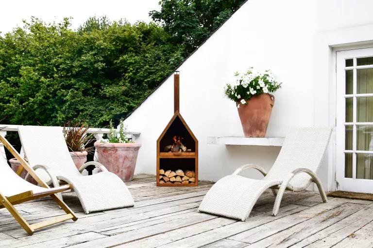 Scandi-chic patio with a unique chiminea as a heat source