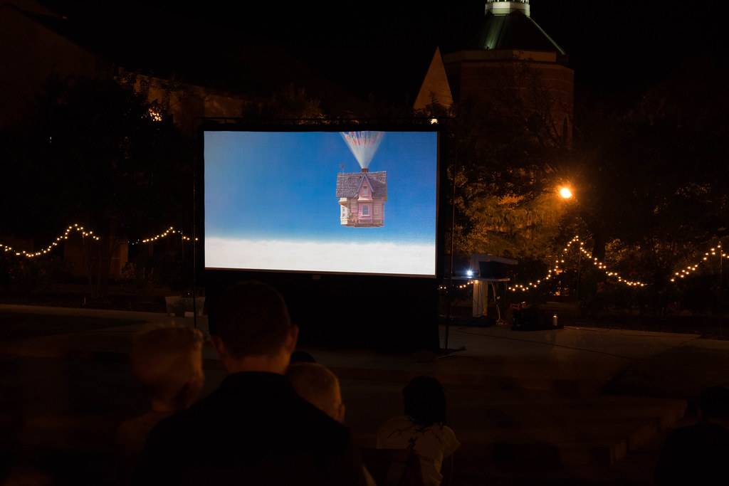 Garden movie night setup with the movie "Up" on the big white screen