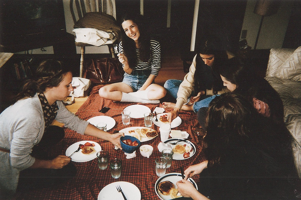A group of friends enjoying an indoor picnic setup