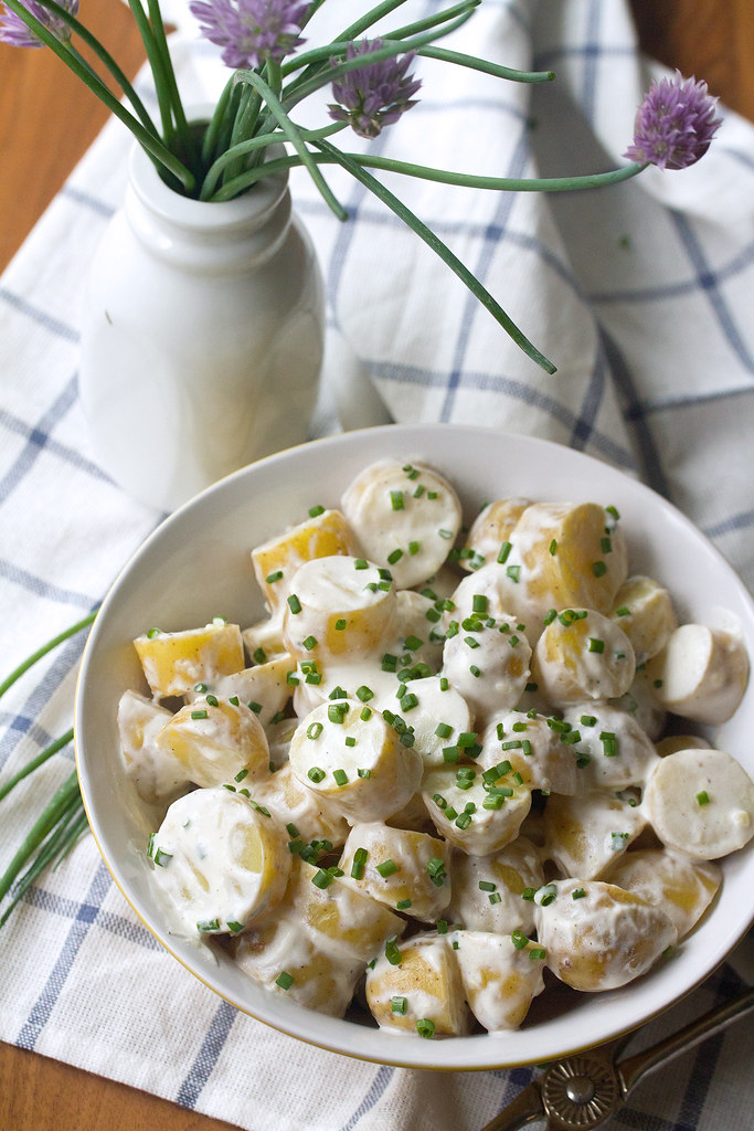 A bowl of potato salad sprinkled with chives