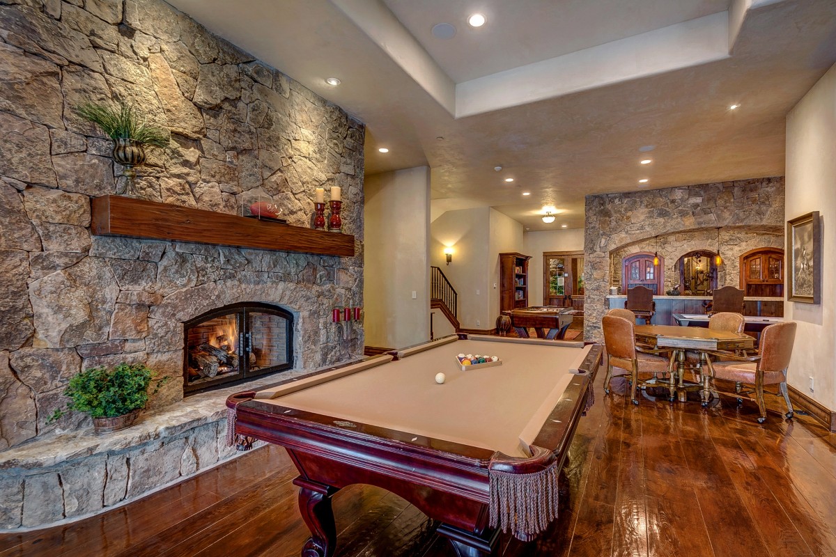 Modern and luxurious man cave interior with stone fireplace