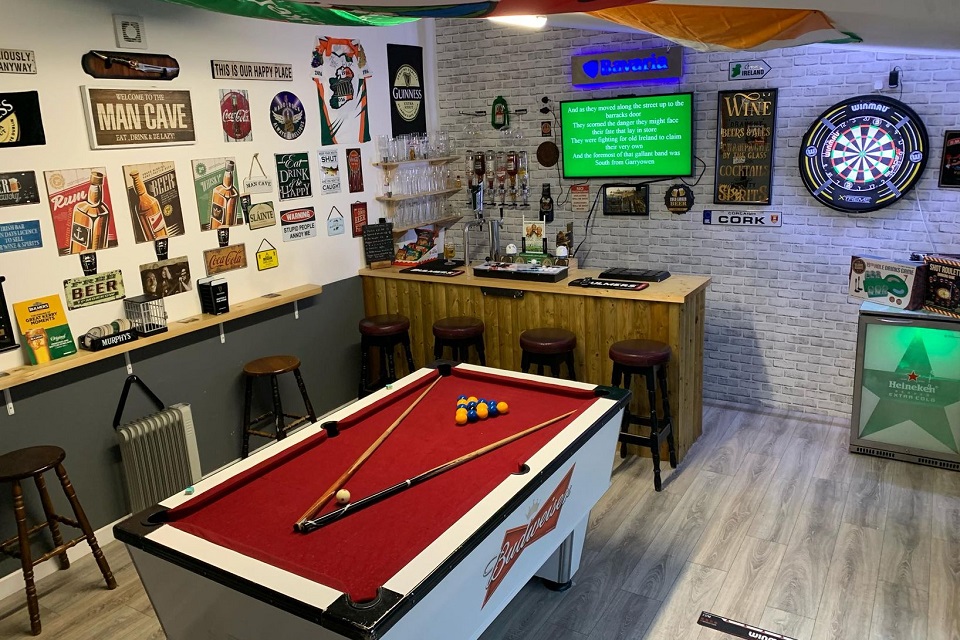 Man cave with a pool table setup