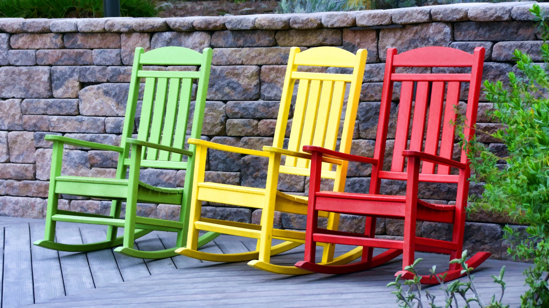 Colourful outdoor rocking chairs in green, yellow and red colours