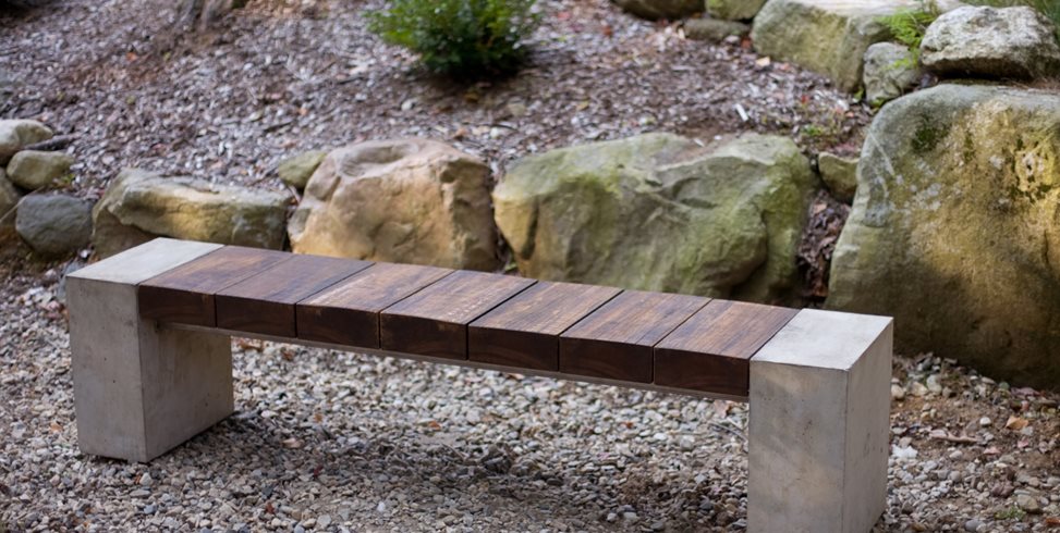Garden bench made from wood, concrete, and metal