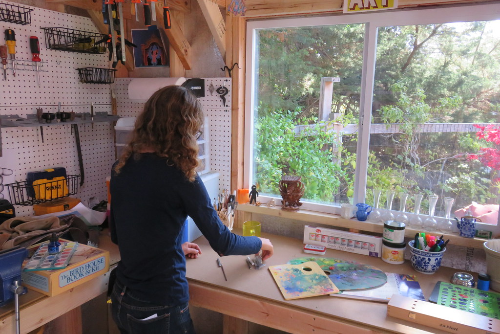 A woman organising her art she shed studio