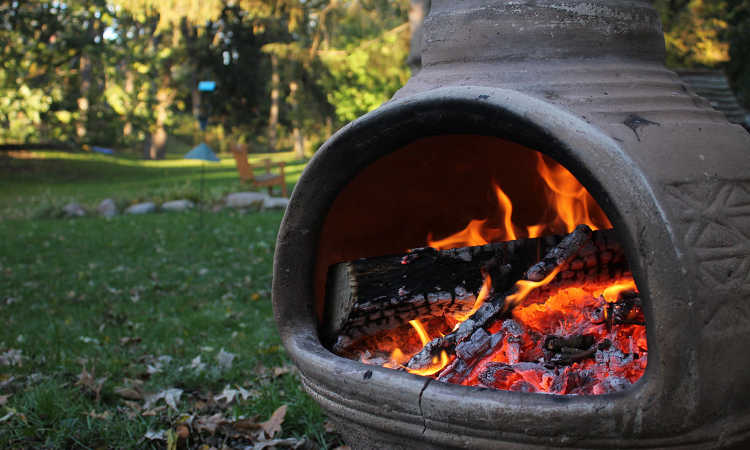 Clay chiminea with large opening for fire