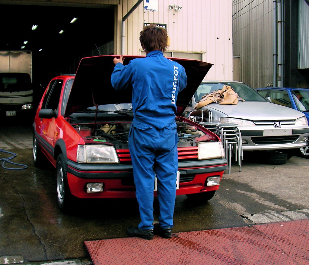 A technicians doing a final car checkup