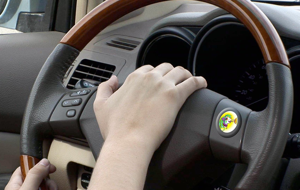 A person pressing steering wheel's horn