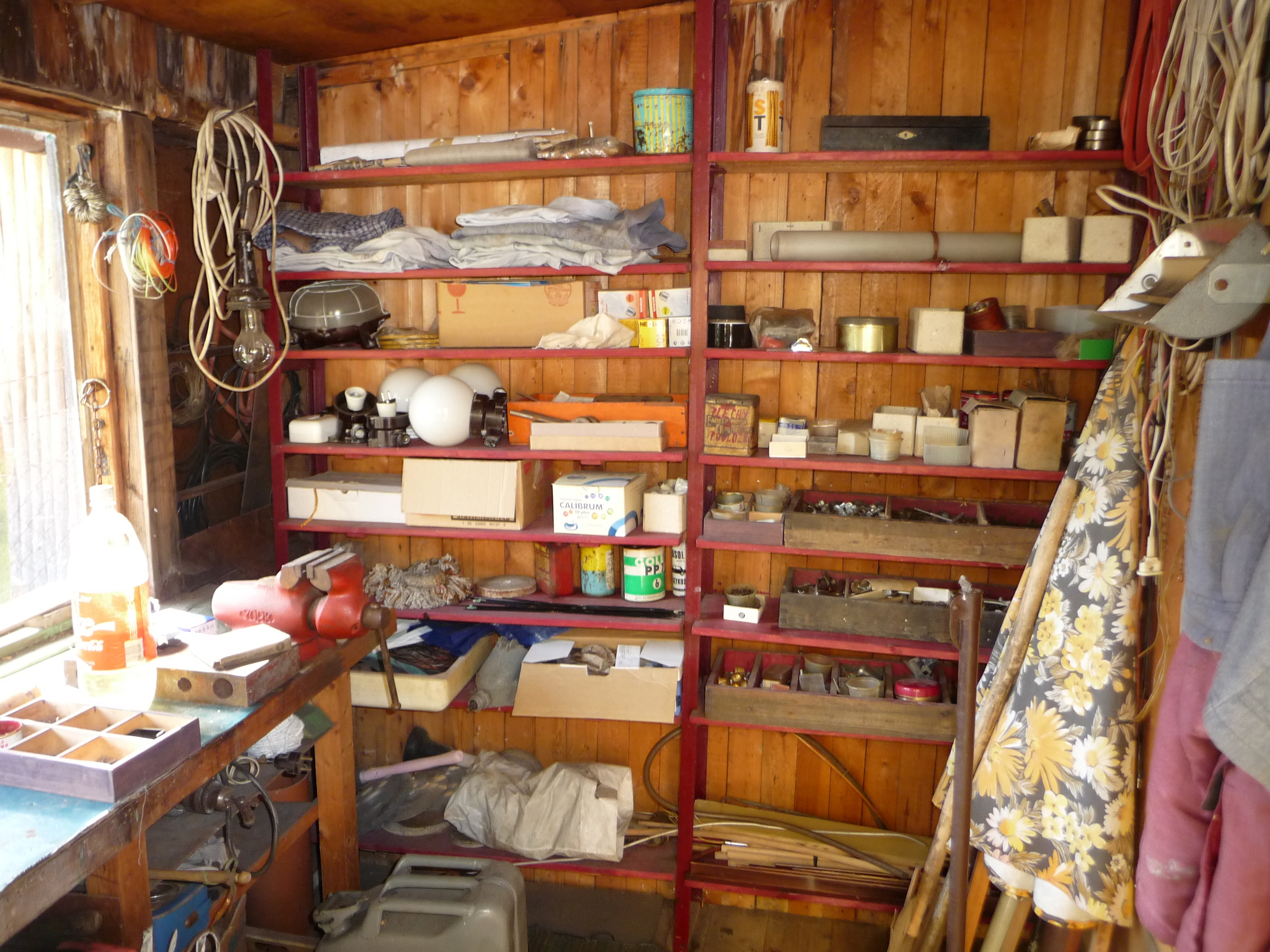Two freestanding shelving units inside a shed