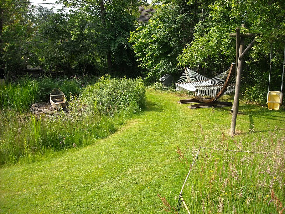 A hammock situated in a nearby garden pond