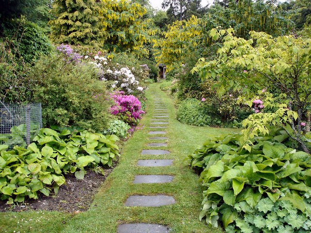 English garden landscape with stone pathway