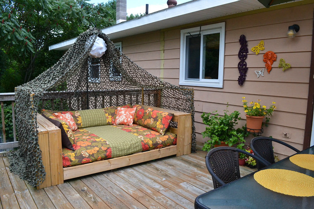 Wooden sofa daybed on a decked patio