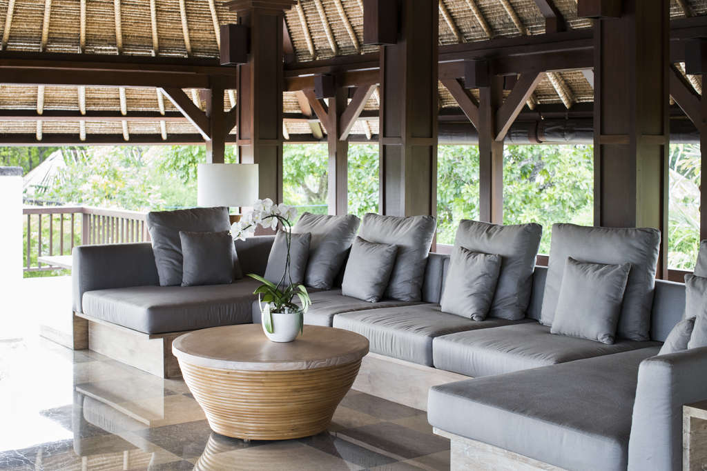 Low outdoor garden sofa with grey cushions