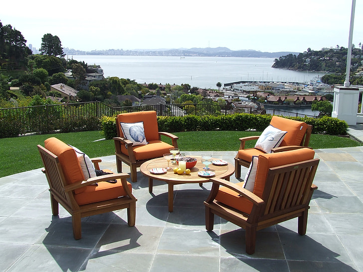 Garden chairs with bright orange cushions on each