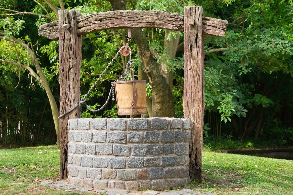 French garden design with a stone wishing well