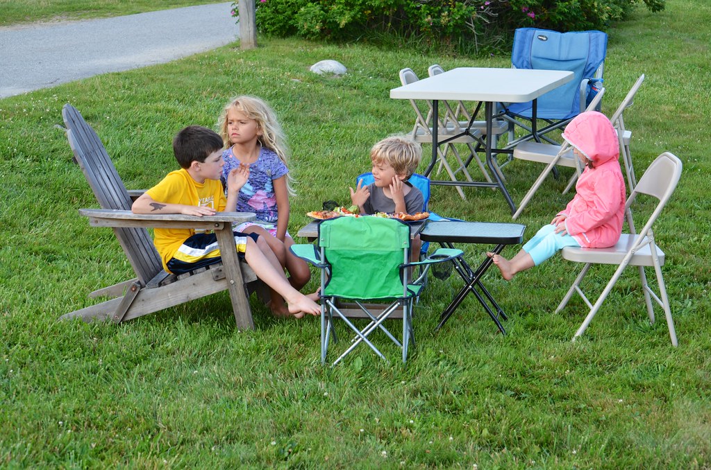 Kids having a small picnic with a mini table