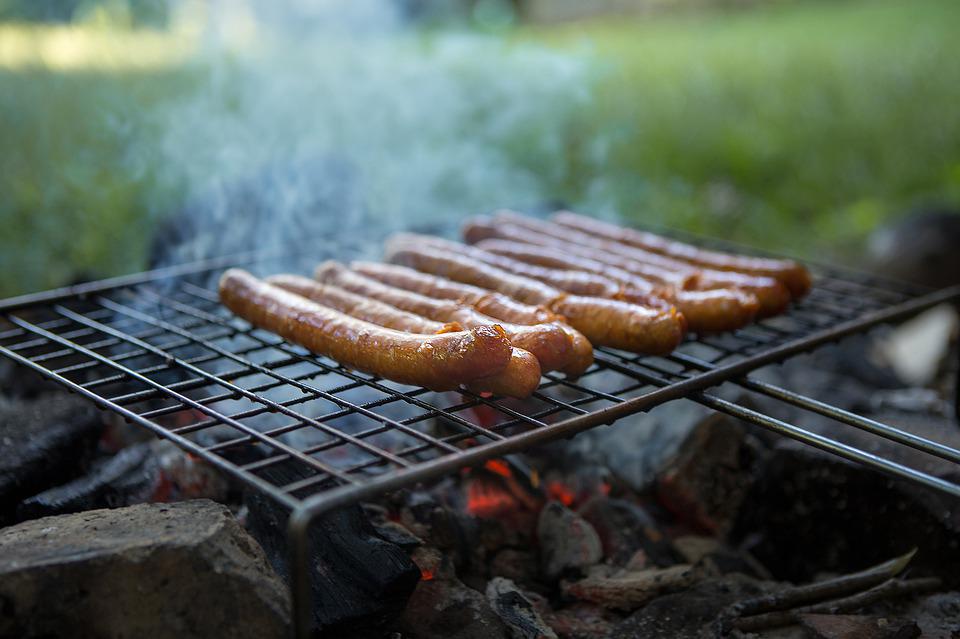 Sausages being grilled on a DIY charcoal grill