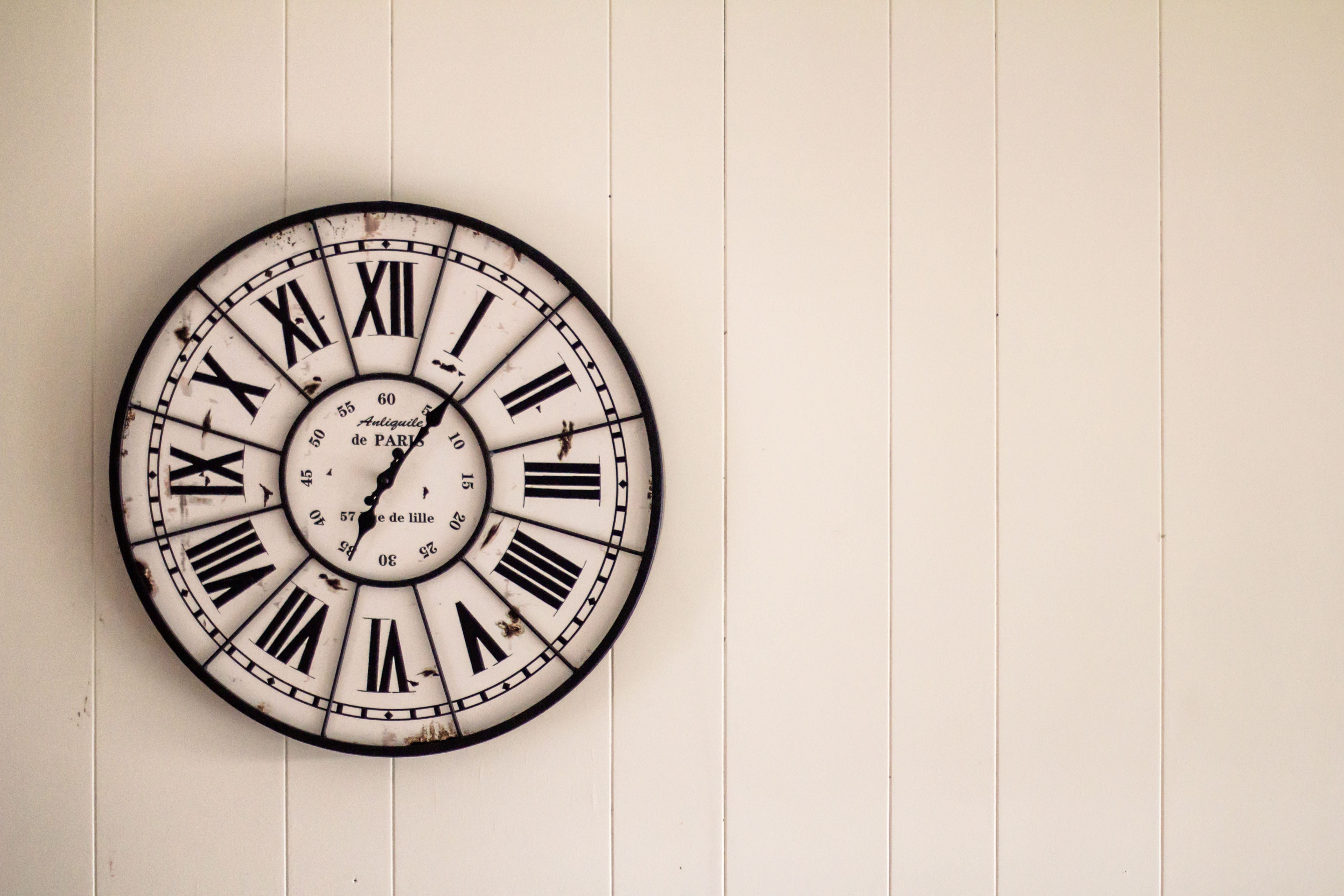 Classic wall clock on a white wall