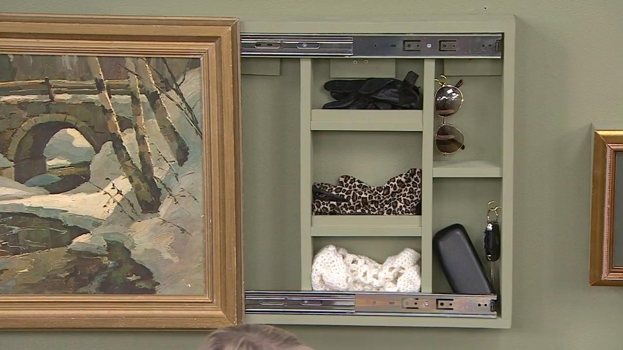 Hidden storage behind a picture frame