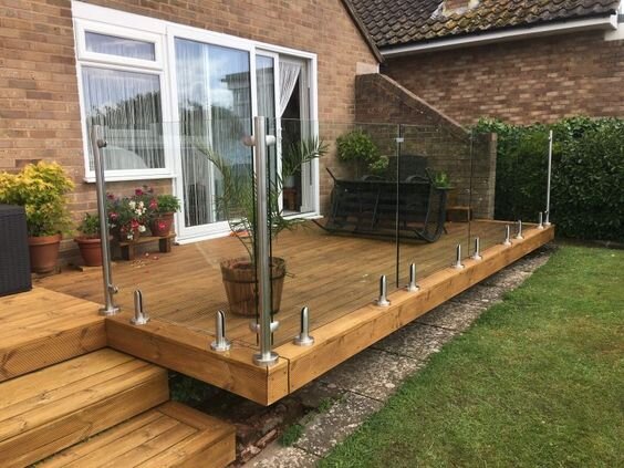 Small garden decking with glass frame