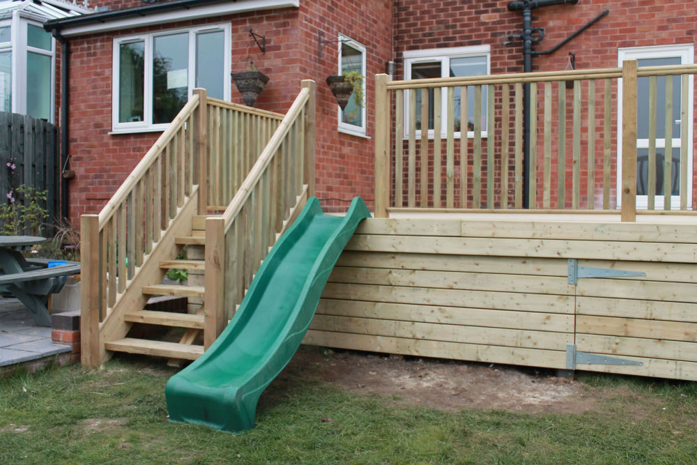 Raised decking with slide for kids