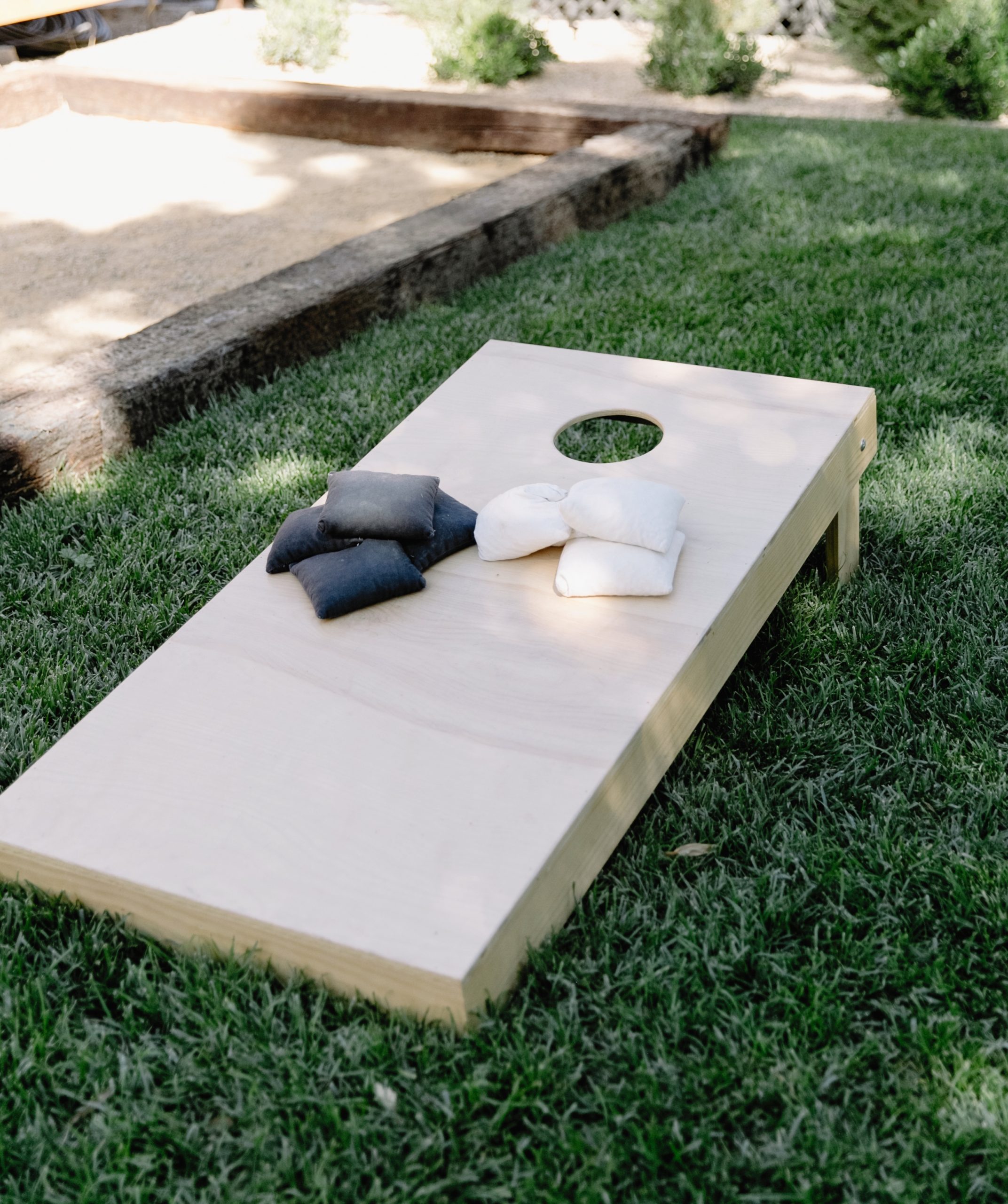 Summer garden idea with a lawn game setup (corn hole)