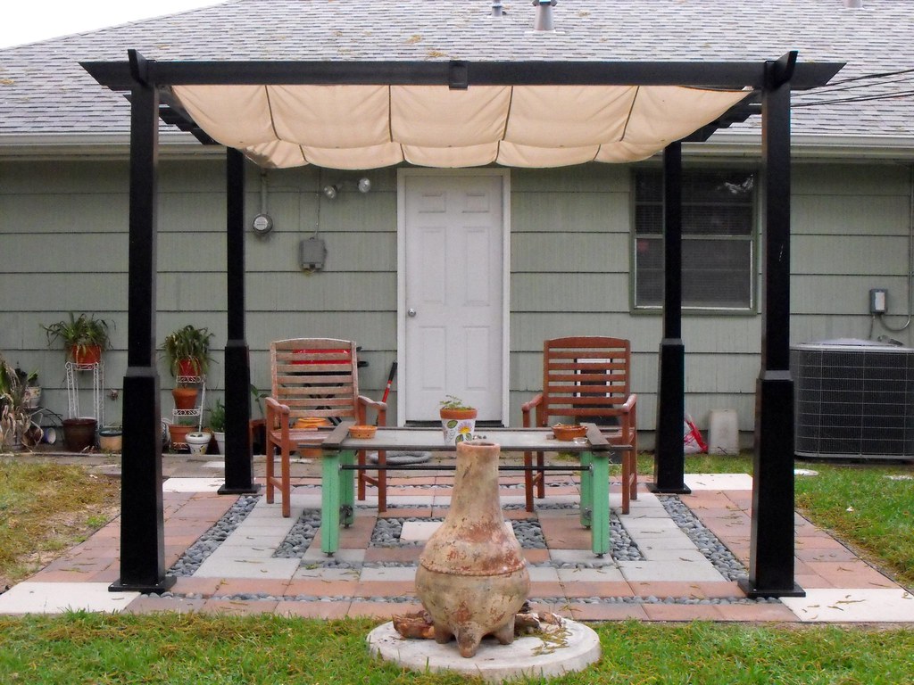 Mini garden seating area covered on a pergola awning