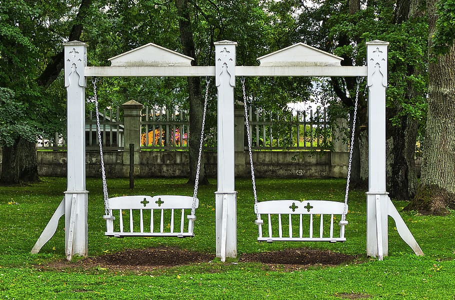 Two white wooden bench swing