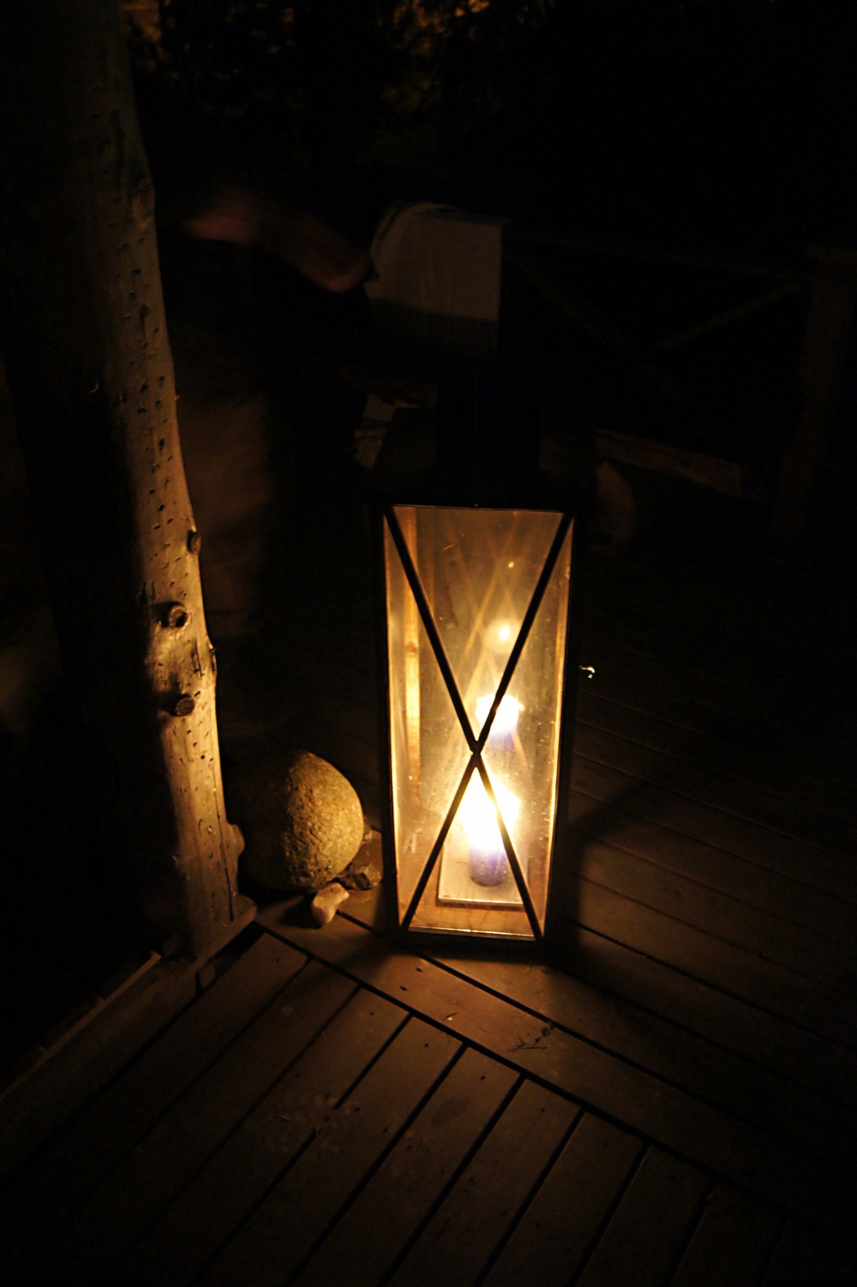 Lantern with a lit candle inside creating a ambient glow