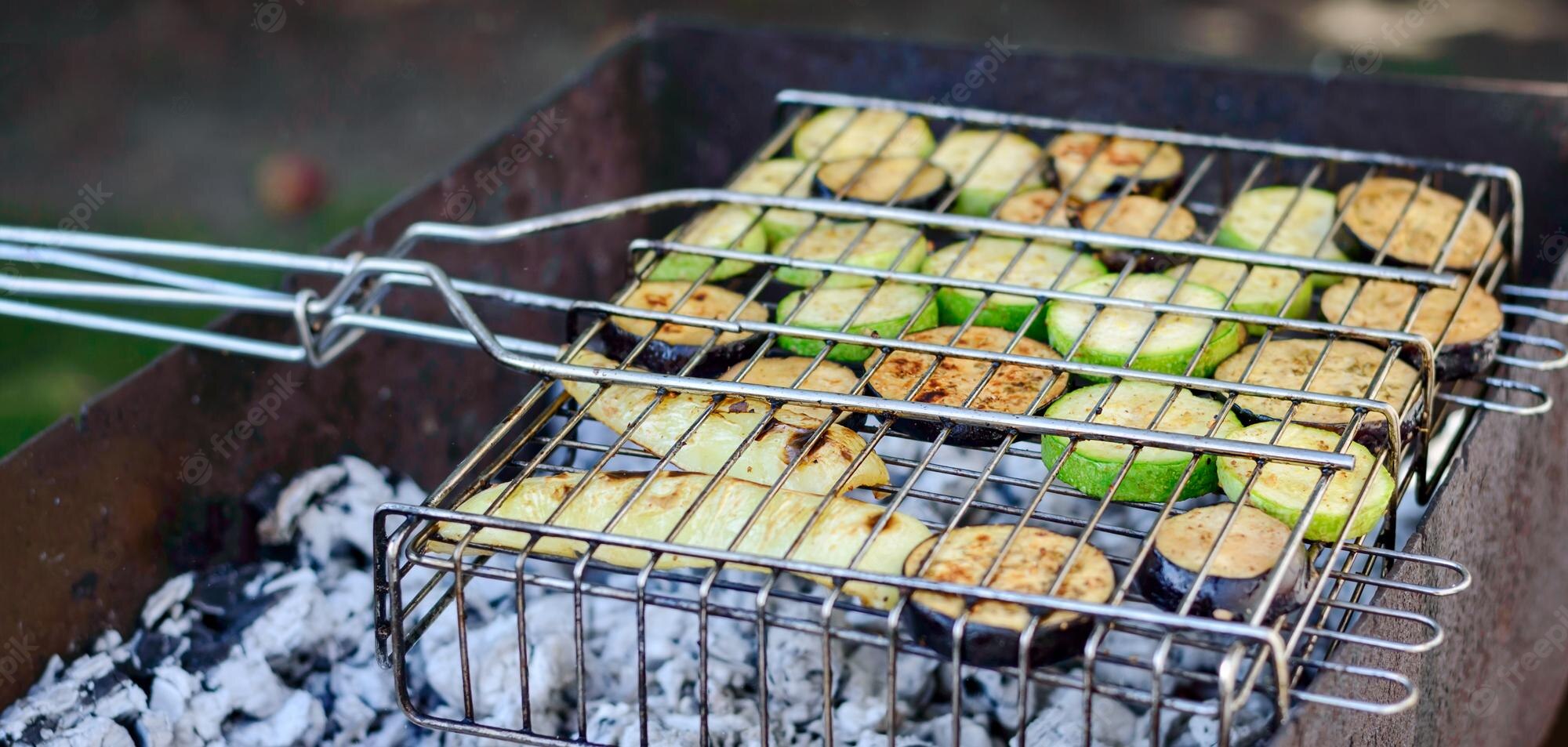 Vegetable being grilled inside kabob grilling baskets