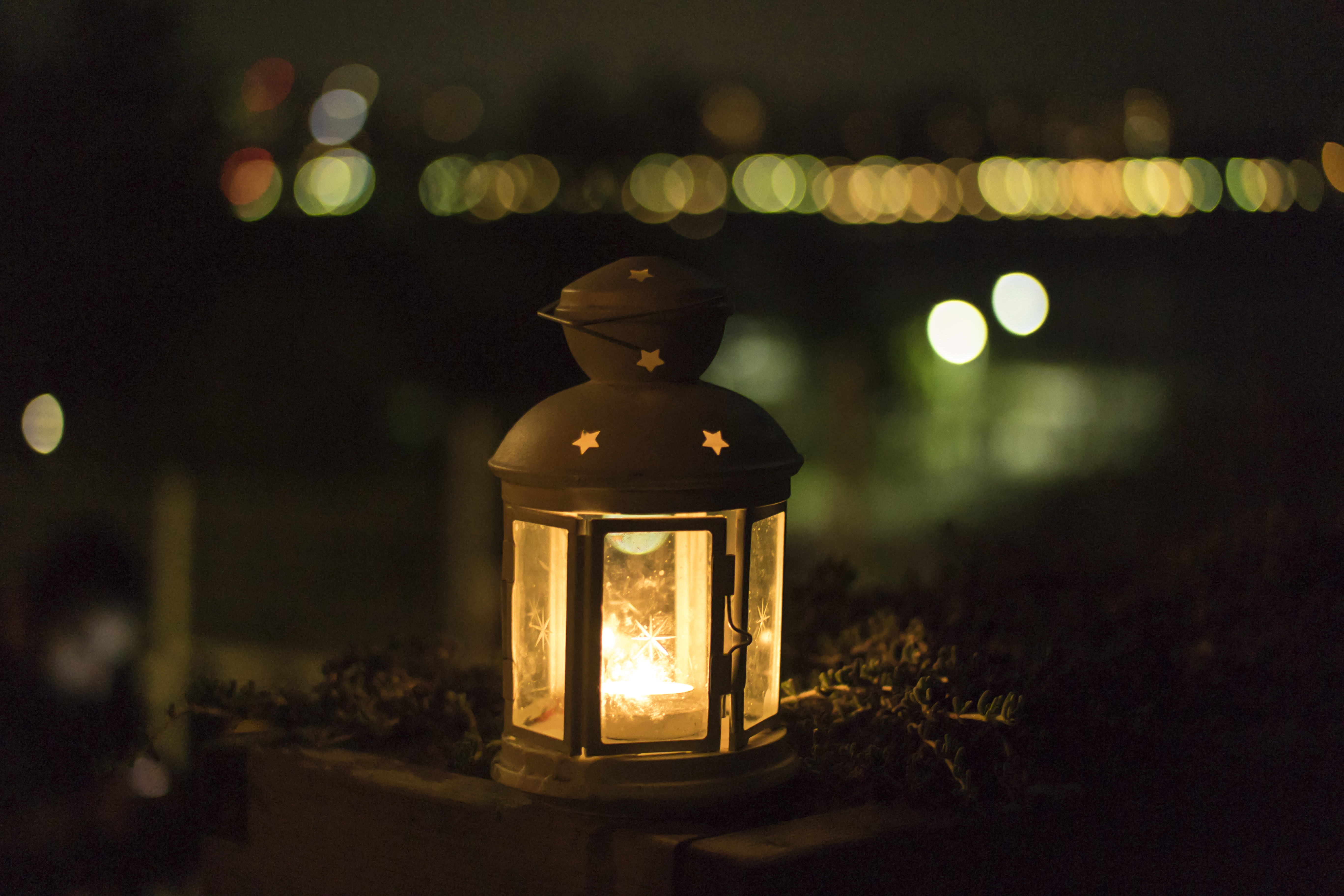 Lit candle lantern at night