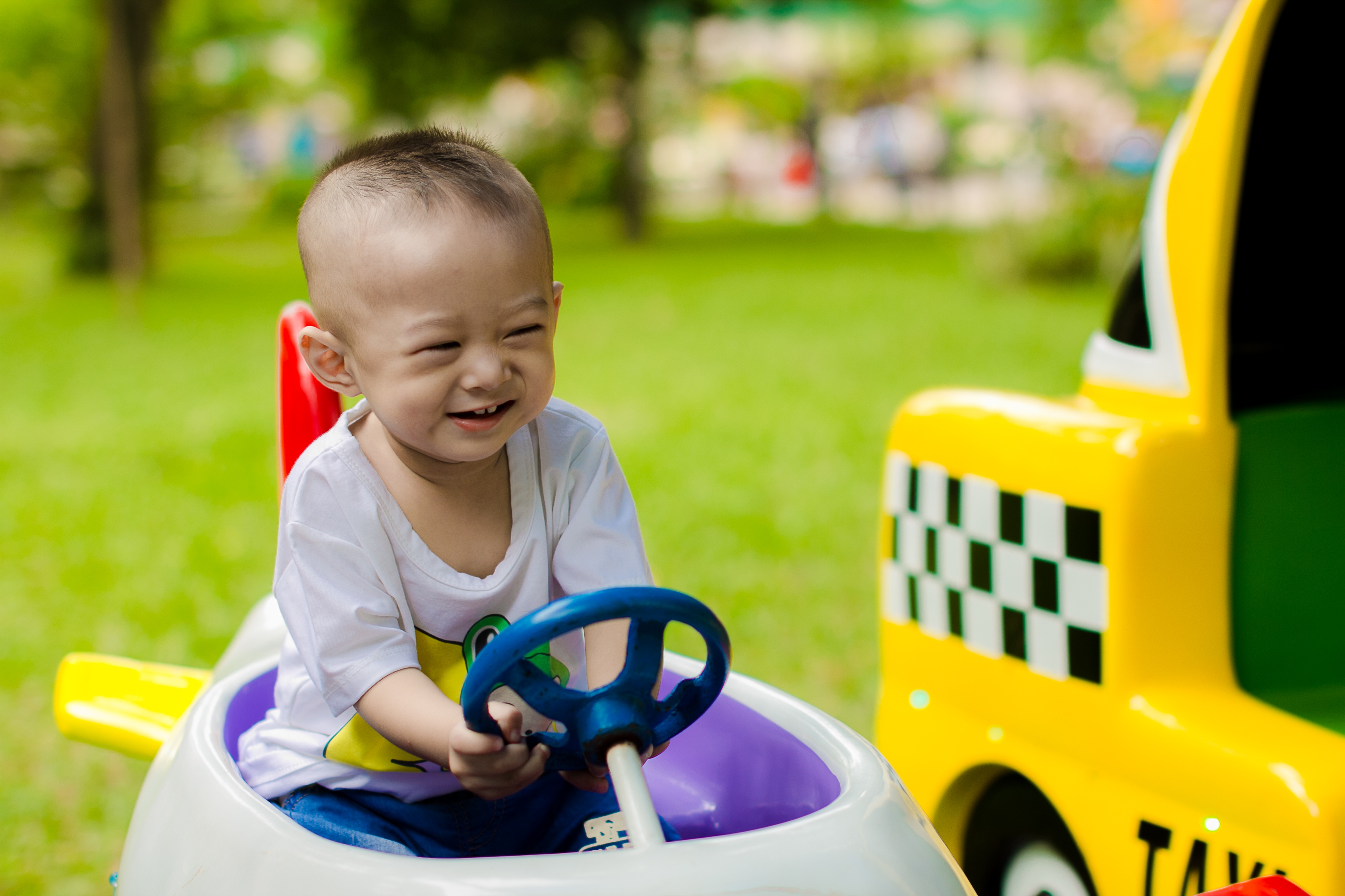 A toddler riding a ride-on truck outdoors