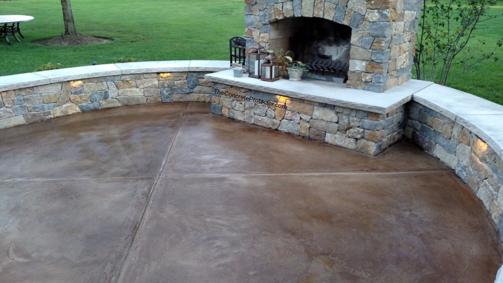 Concrete patio with stone fireplace