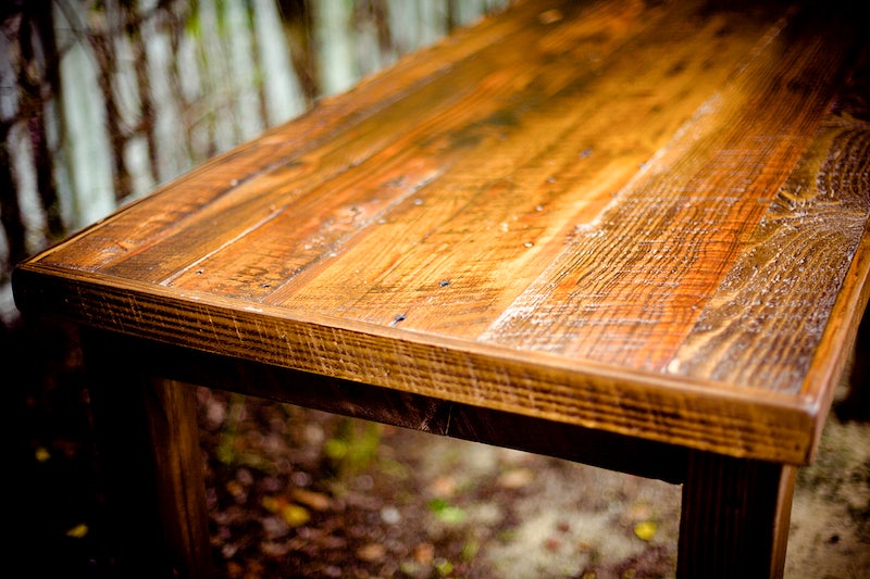 Close up shot of a wooden table showing signs of scratches and fading