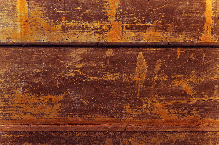 Close up shot of a wooden furniture surface showing signs of fading and discolouration