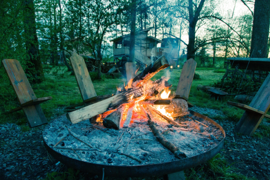 Lit garden fire pit using wood