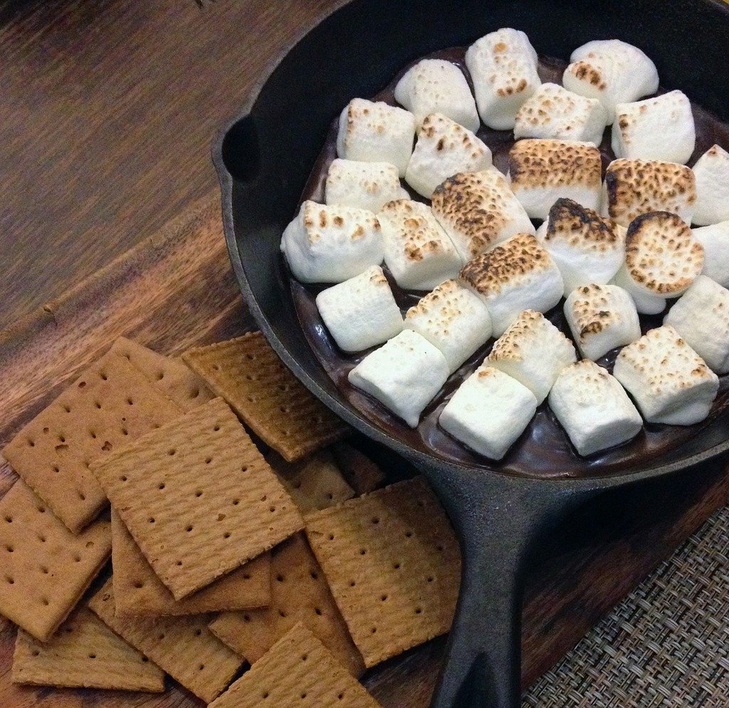 A skillet filled with marshmallows and grahams.