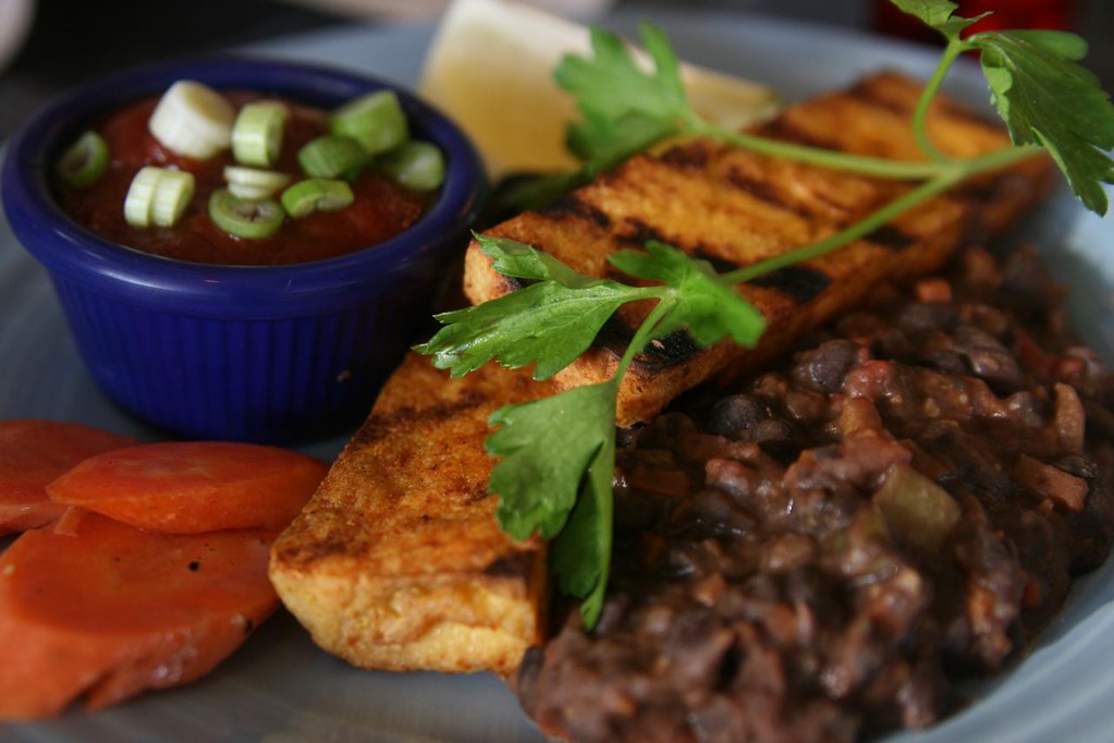 Grilled tofu with homemade BBQ sauce, a side of black beans and some veggies.