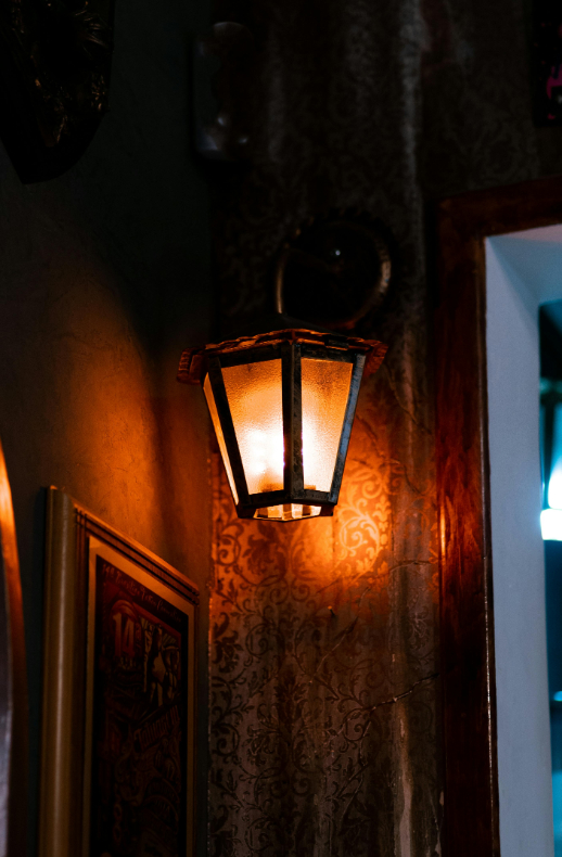 Lit lamp mounted on the wall.